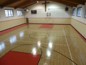 Red themed indoor basketball court at a church