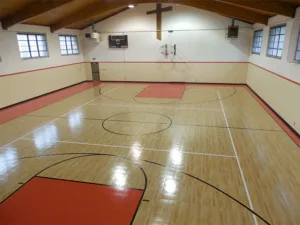 Red basketball court inside a church