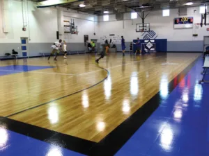 A group of players on an indoor basketball court at a Boys & Girls Club facility