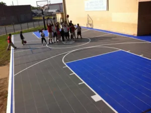 A group of kids gathering around a basketball hoop at the North Little Rock Boys & Girls Club