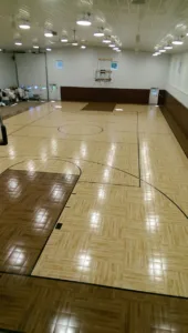 Indoor gymnasium with wall-mounted basketball hoops