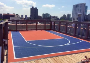 Red and blue themed balcony game court in the middle of a city