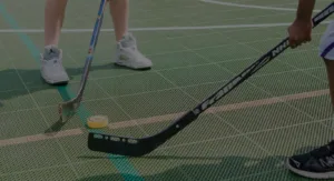 Floor hockey on a game court surface