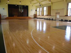 Indoor gymnasium with basketball hoop and stage