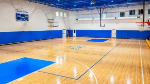 Florida indoor game court with basketball hoop and multi-sport surface